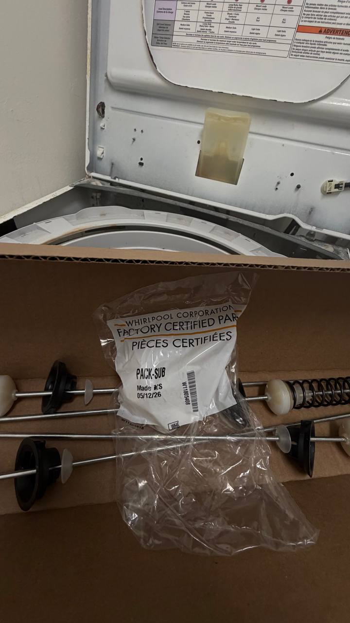 Close-up of Whirlpool suspension kit replacement parts